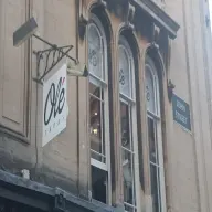 The terracotta door entrance to Olé Tapas at 1 John Street, Bath